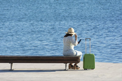 Rear view of man sitting on bench
