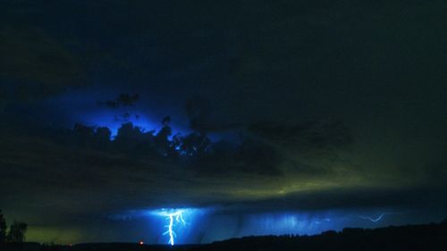 Low angle view of lightning in sky at night