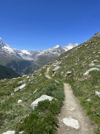 Scenic view of mountains against clear blue sky