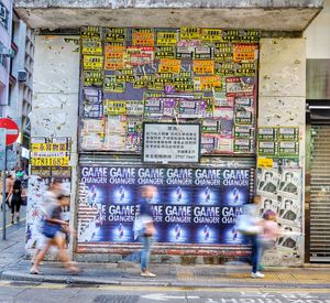 People walking on footpath in city