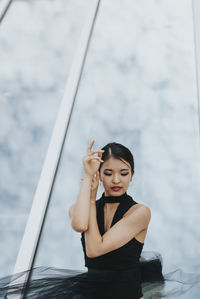 Young woman looking away while standing in water