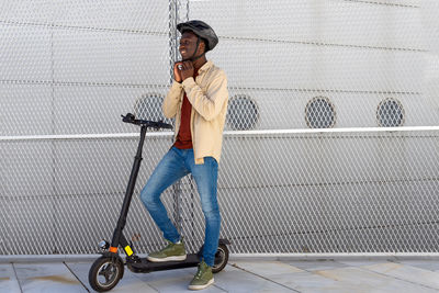 Side view of a young man cycling