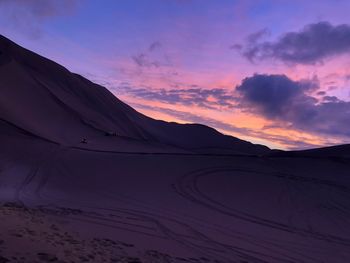 Scenic view of desert against sky during sunset