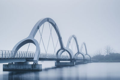 Bridge over river against clear sky