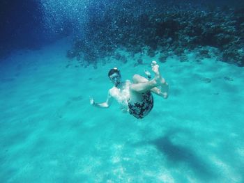 High angle view of boy swimming in sea