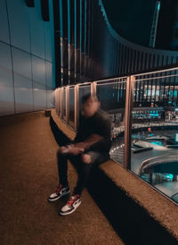 Man in car against building at night