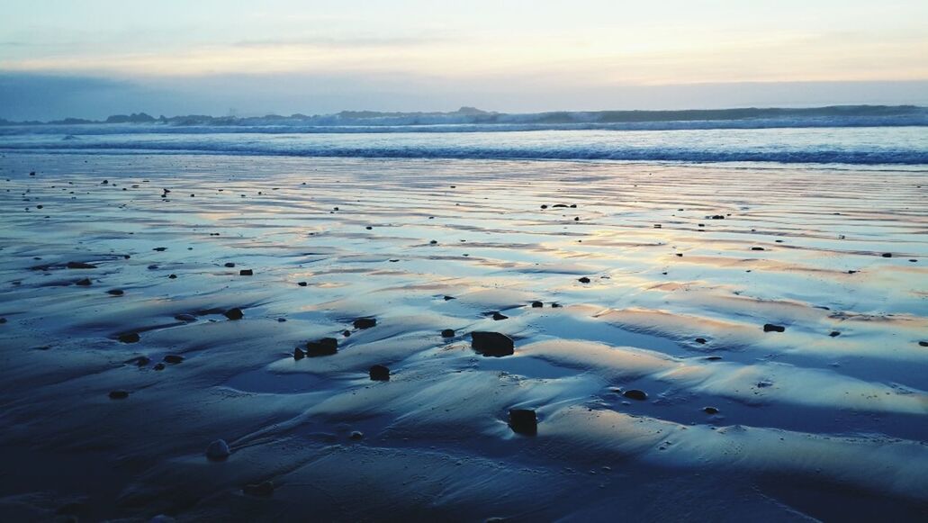 water, beach, sea, tranquil scene, tranquility, scenics, beauty in nature, sky, sunset, shore, nature, sand, idyllic, horizon over water, reflection, cloud - sky, outdoors, coastline, bird