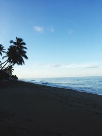 Scenic view of beach against clear blue sky