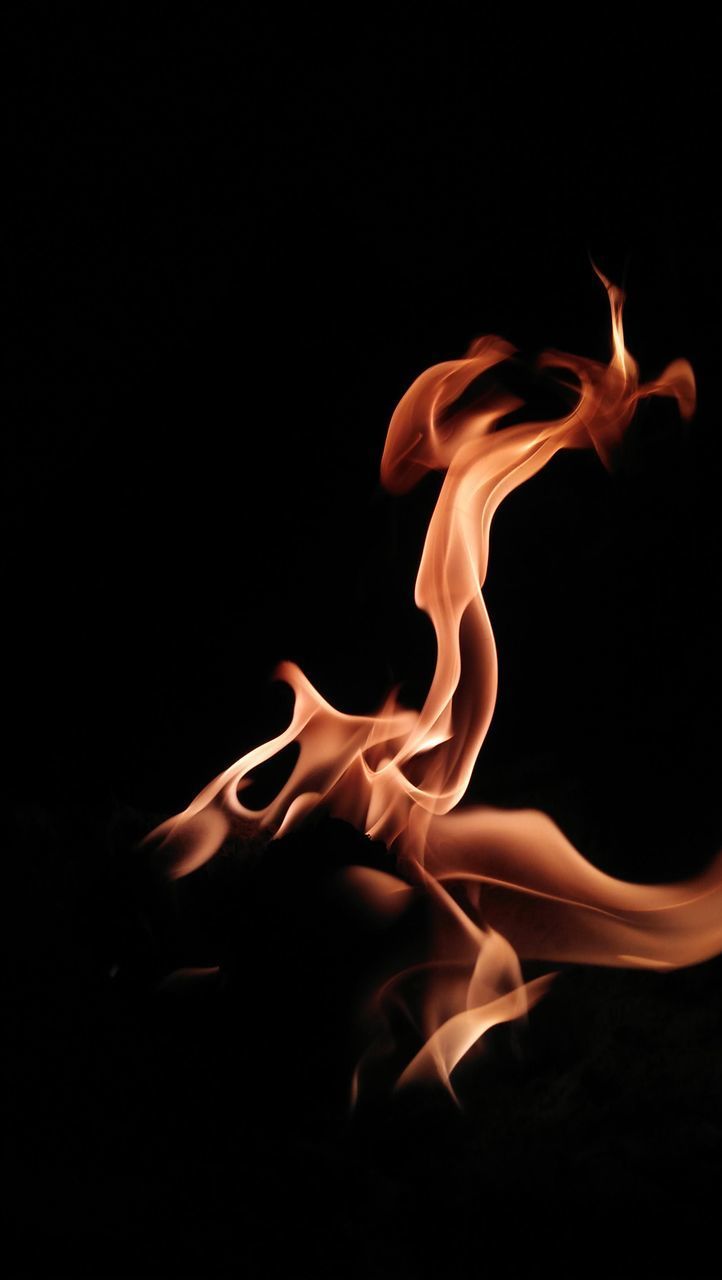 CLOSE-UP OF BURNING FIRE AGAINST BLACK BACKGROUND