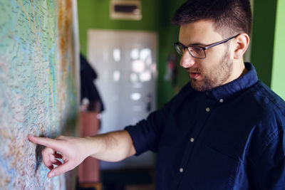 Portrait of man standing against wall