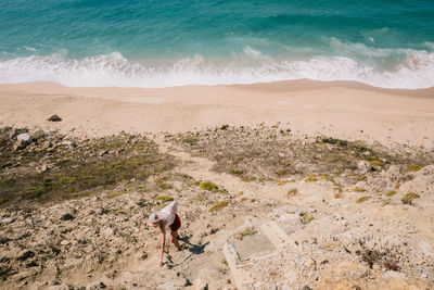 High angle view of woman at beach during sunny day