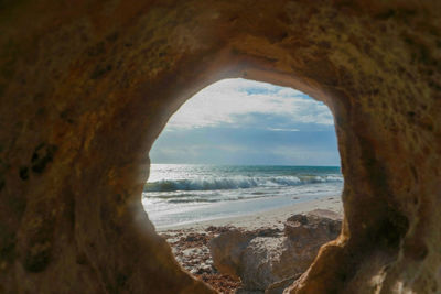 Scenic view of sea against sky seen through arch