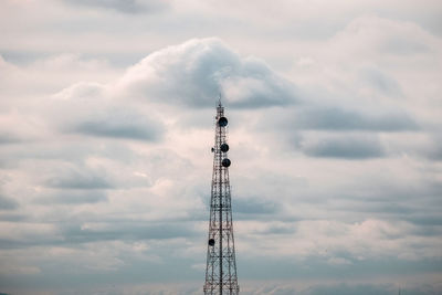 Low angle view of communications tower against sky