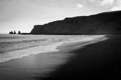 People on beach against sky