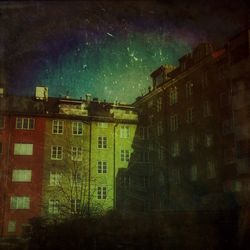 Buildings against sky at night