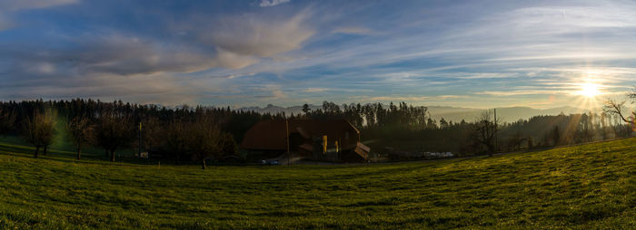 Scenic view of field against sky during sunset