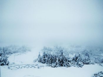 Frozen landscape against sky during winter