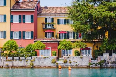 Residential building by river against sky