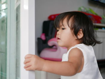 Cute girl looking away at home