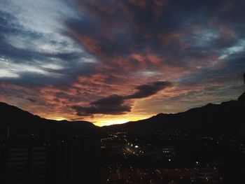 Silhouette buildings against sky during sunset