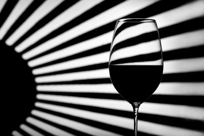 Close-up of wineglass against patterned wall