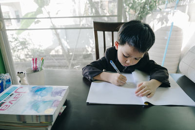 Boy sitting on table