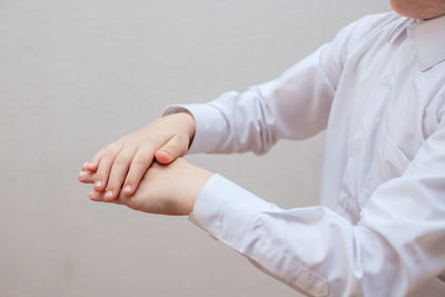 Midsection of man standing against white background