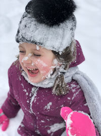 Close-up of happy girl with snow