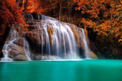 Scenic view of waterfall in forest during autumn