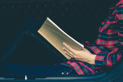 High angle view of woman reading book