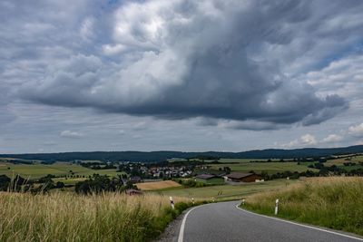 Empty road along countryside landscape