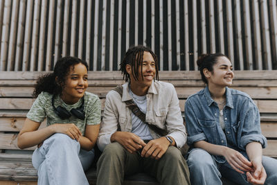 Teenagers sitting in skate park and looking away