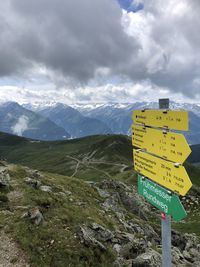 Information sign on landscape against sky