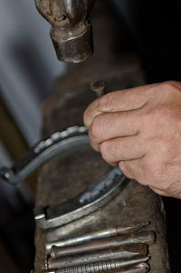 Close-up of man working at workshop