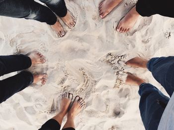 Low section of people standing on beach