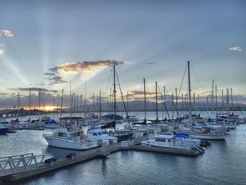 Boats moored in calm sea against sky