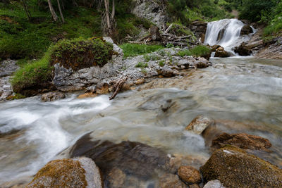 Stream flowing through rocks in forest