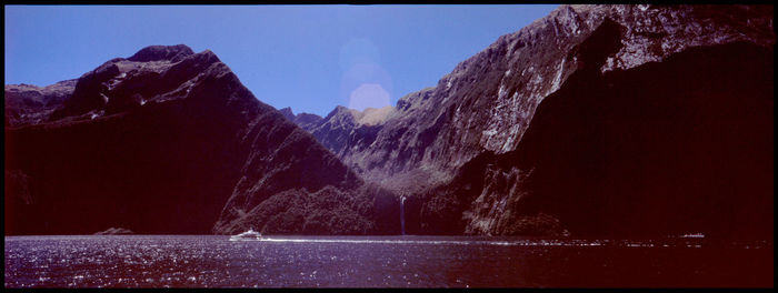 Panoramic view of sea and mountains against clear sky