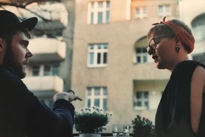 Man with woman against city buildings