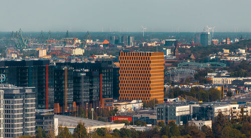 High angle view of buildings in city against clear sky