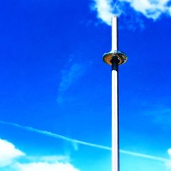 Low angle view of vapor trail against blue sky