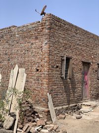 Low angle view of old building against clear sky