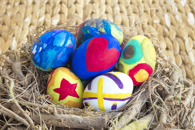 High angle view of multi colored bird in nest