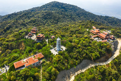 High angle view of trees and buildings against mountains