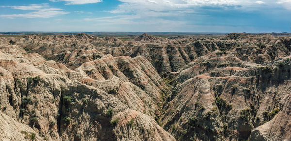 Scenic view of mountain range against blue sky at badlands national park