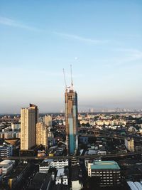 High angle view of buildings in city against cloudy sky