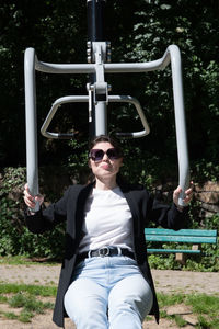 Brunette woman is engaged in a street sports simulator in the park, sports