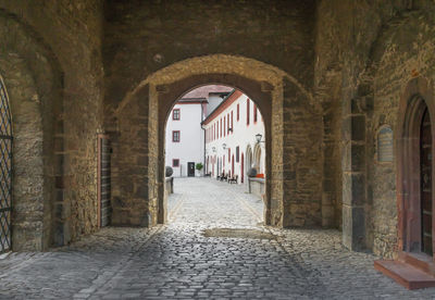 Empty alley amidst buildings in city