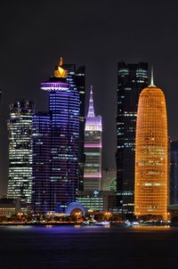 Illuminated buildings in city at night