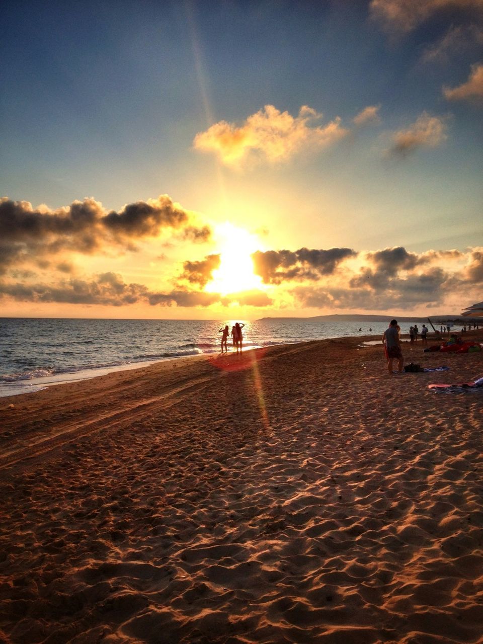 sea, beach, sunset, horizon over water, water, sky, sun, shore, scenics, leisure activity, sand, lifestyles, tranquil scene, beauty in nature, cloud - sky, tranquility, silhouette, sunlight, nature